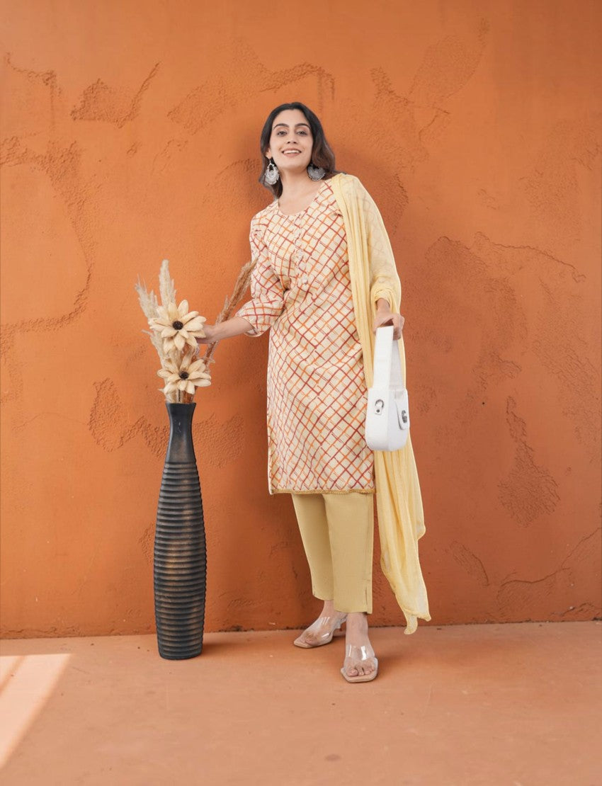 Eelika beige and orange checkered organza salwar suit with 3/4th sleeves, cotton trousers, and a matching dupatta.