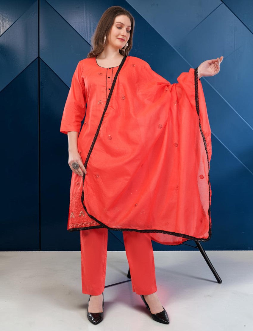 Model wearing an Eelika coral red cotton salwar suit with 3/4 sleeves, black lace border, and matching dupatta