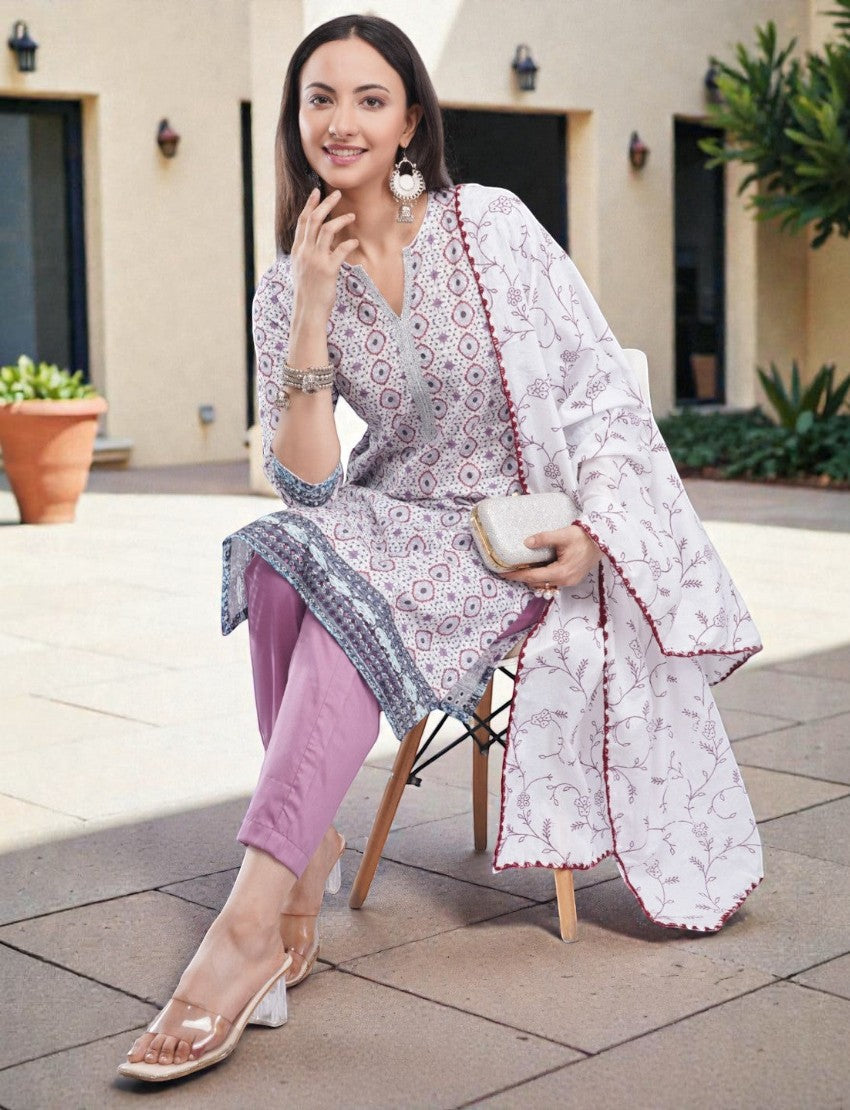 Eelika cotton kurta set featuring a printed V-neck calf-length top, mauve trousers, and a matching floral dupatta.