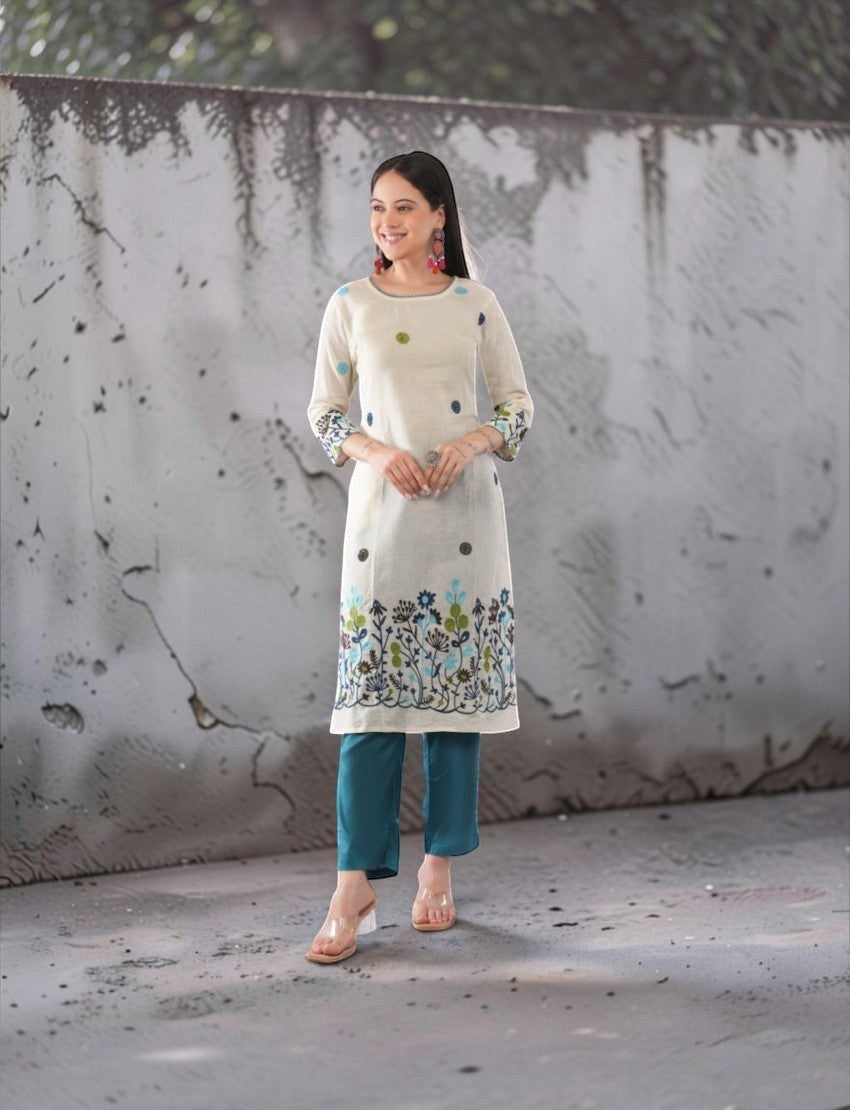 Eelika cotton salwar suit set featuring a cream calf-length kurta with floral embroidery and teal trousers