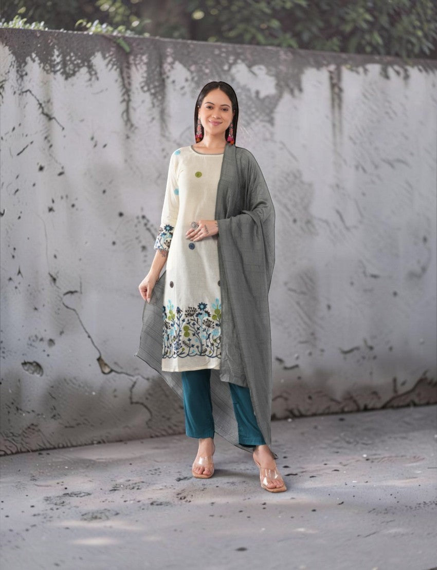 Eelika cotton salwar suit set with cream calf-length kurta, teal trousers, and a grey dupatta with floral embroidery.