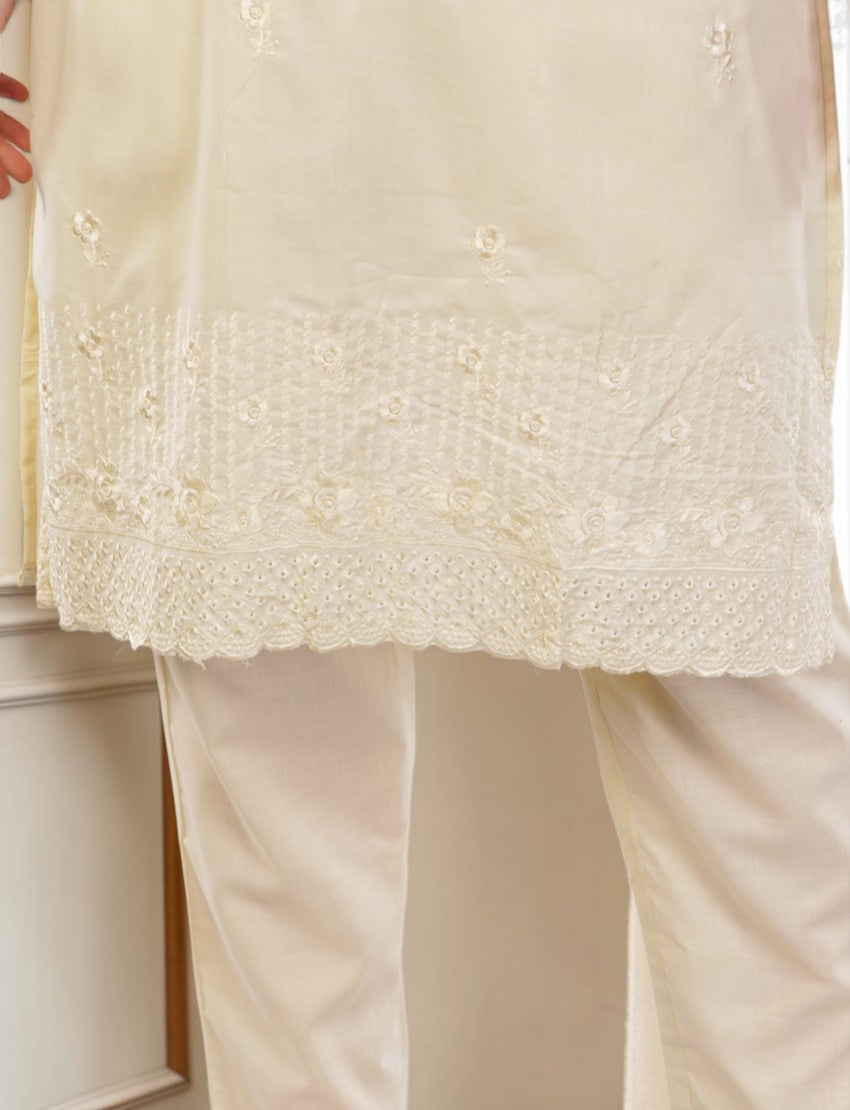 Eelika cream cotton salwar suit set featuring delicate floral embroidery and a scalloped hemline on the knee-length top