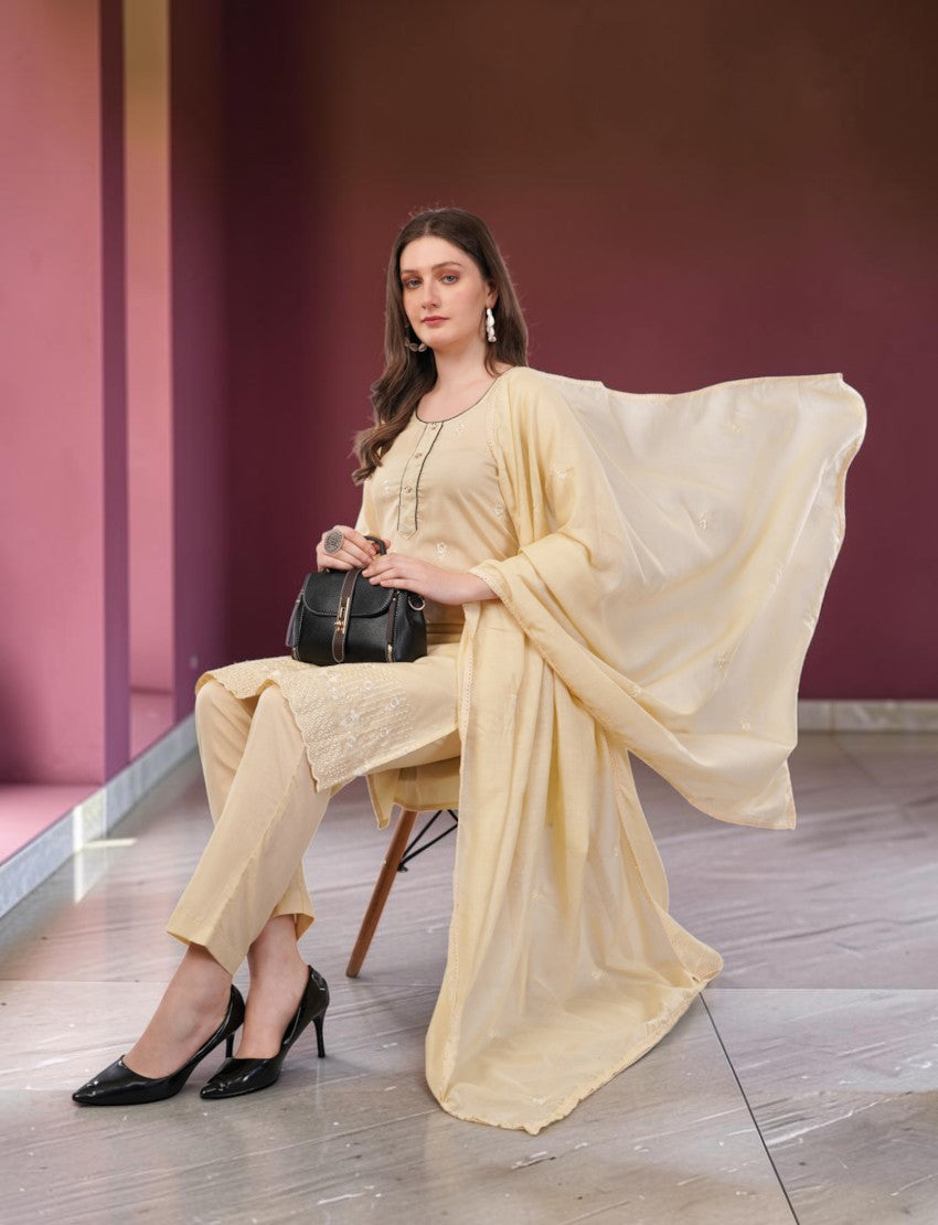 Eelika cream cotton salwar suit set with embroidered kurta, trousers, and matching dupatta worn by a seated model