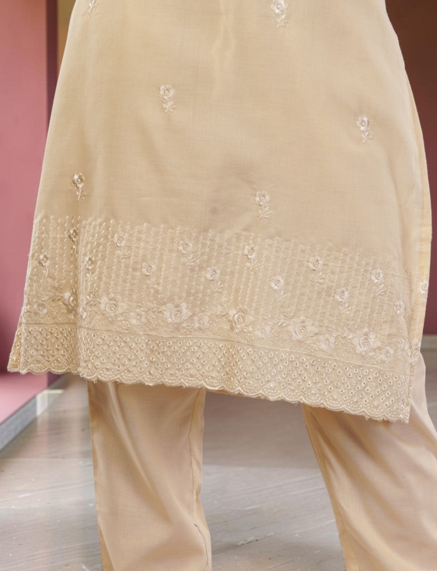 Eelika cream cotton salwar suit featuring delicate floral embroidery and intricate hemline detailing on the kurta