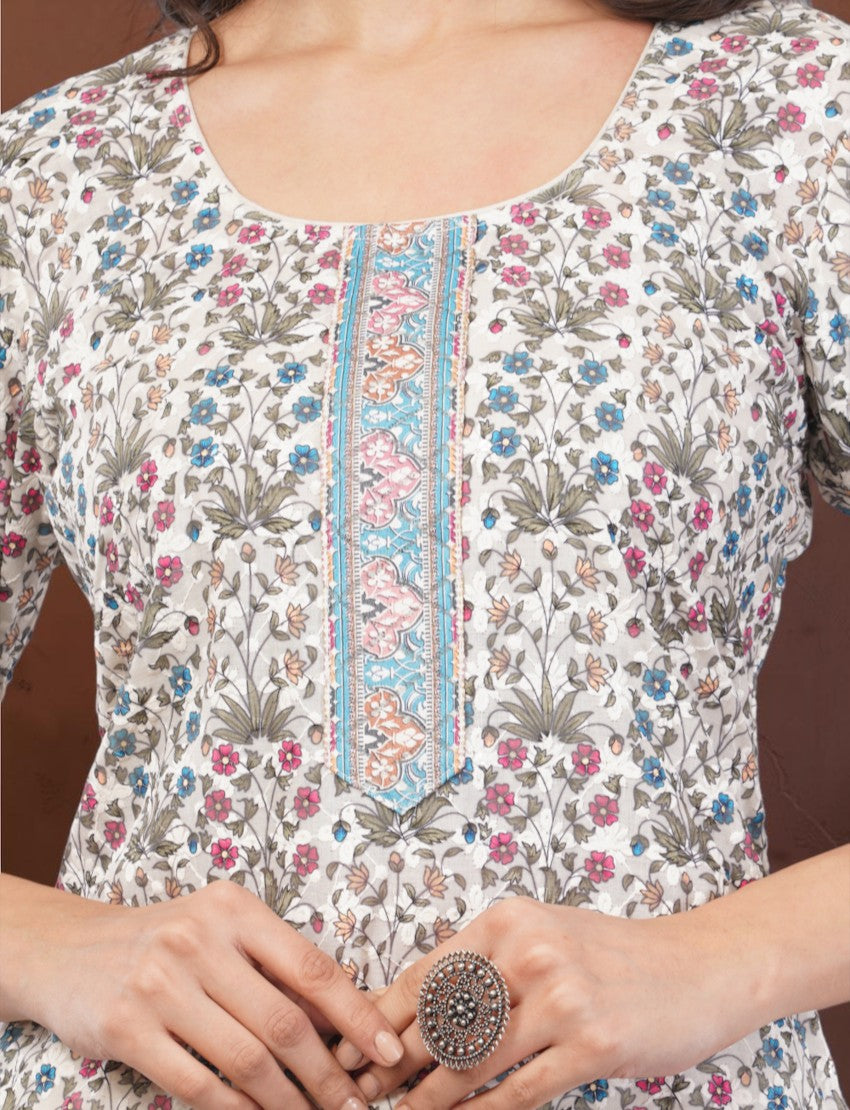 Eelika cotton salwar suit featuring a floral print, round neck, and intricate embroidered placket detail.