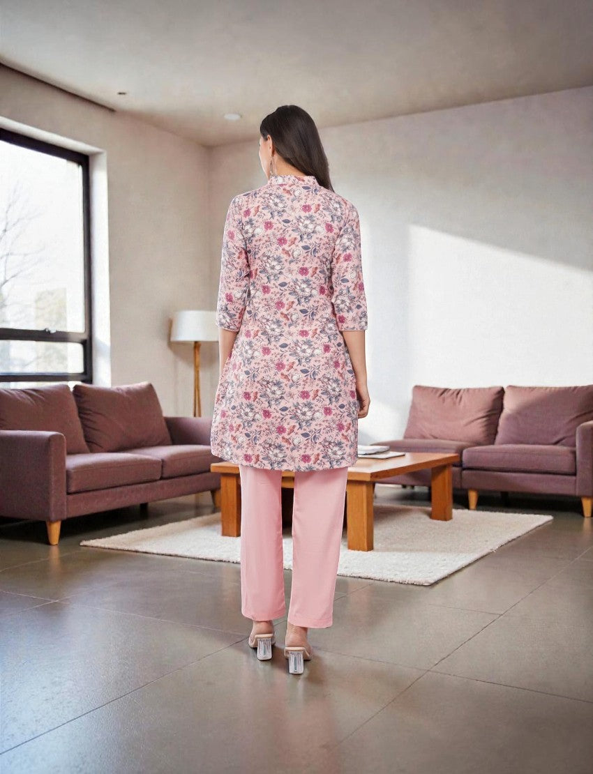 Eelika women's floral print cotton blend calf-length kurta paired with solid pink trousers, back view