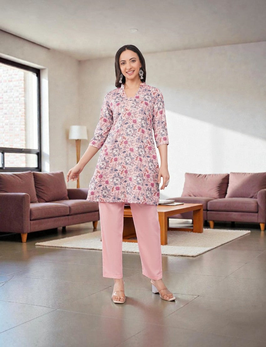 Eelika women's floral print cotton blend kurta with solid pink palazzo pants, featuring a V-neck and 3/4 sleeves.