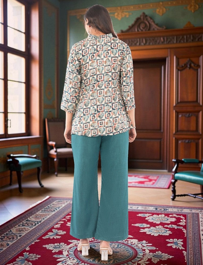 Eelika women's geometric print crepe top with 3/4 sleeves and teal cotton blend trousers in a classic interior.