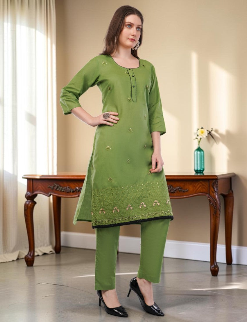 Eelika green cotton salwar suit set featuring knee-length embroidered kurta with 3/4 sleeves and matching trousers