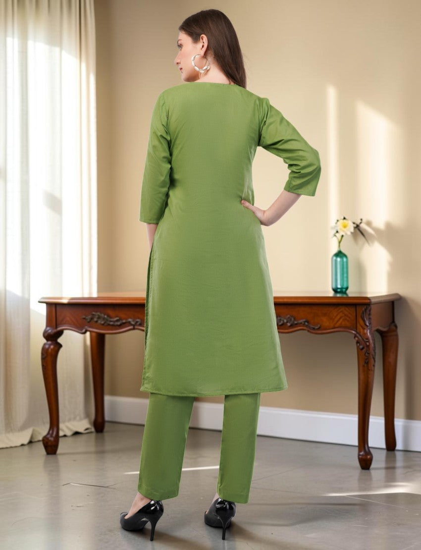 Eelika green cotton salwar suit set featuring a knee-length kurta with 3/4th sleeves and matching trousers