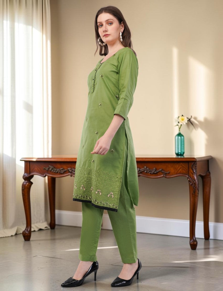 Eelika green cotton salwar suit set with 3/4 sleeves, embroidery, and black lace trim on a model