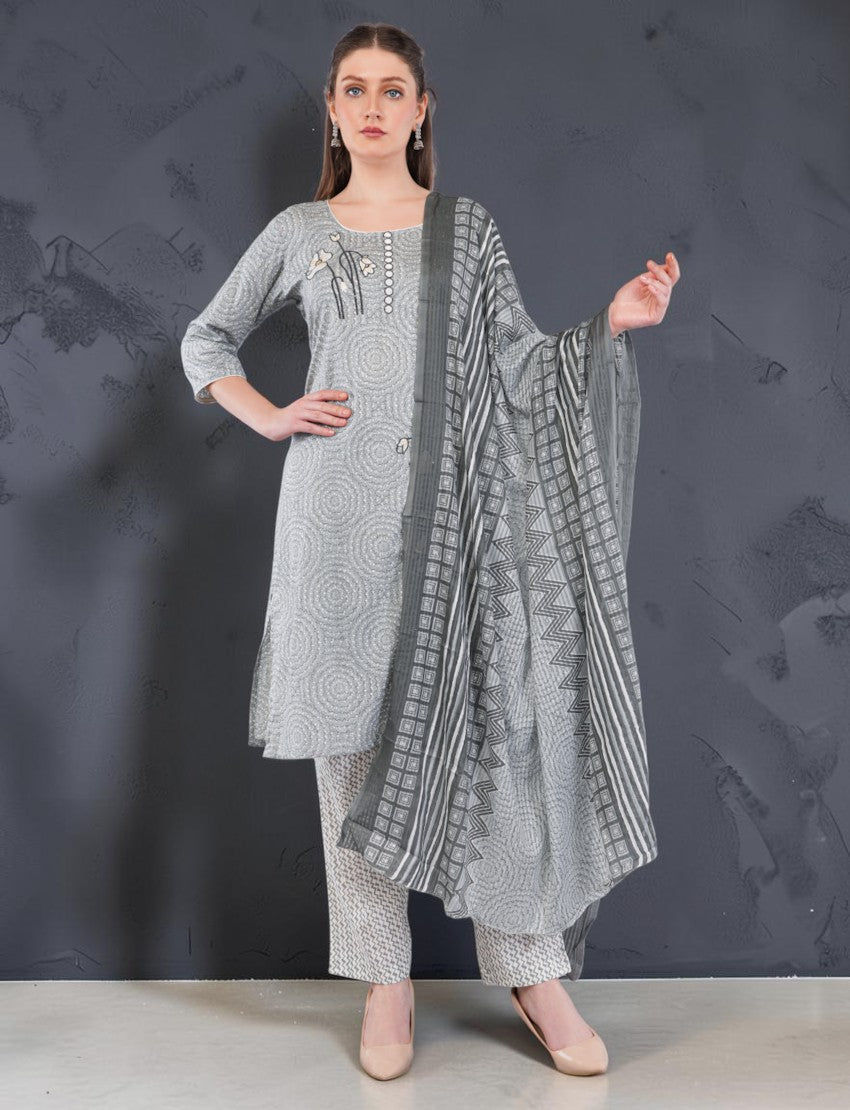Model wearing an Eelika grey cotton salwar suit set with geometric printed kurta, trousers, and matching dupatta.