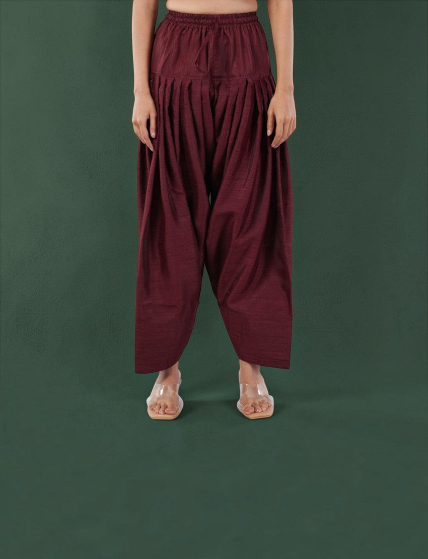 Eelika maroon silk blend farshi salwar with a drawstring waist and pleated design worn with clear sandals