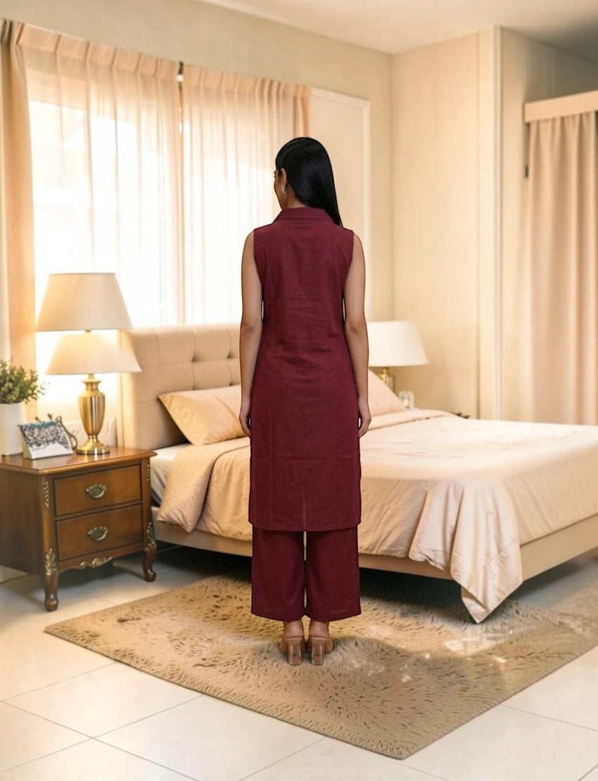 Back view of a woman wearing a maroon sleeveless cotton salwar suit by Eelika with a collared kurta and trousers.