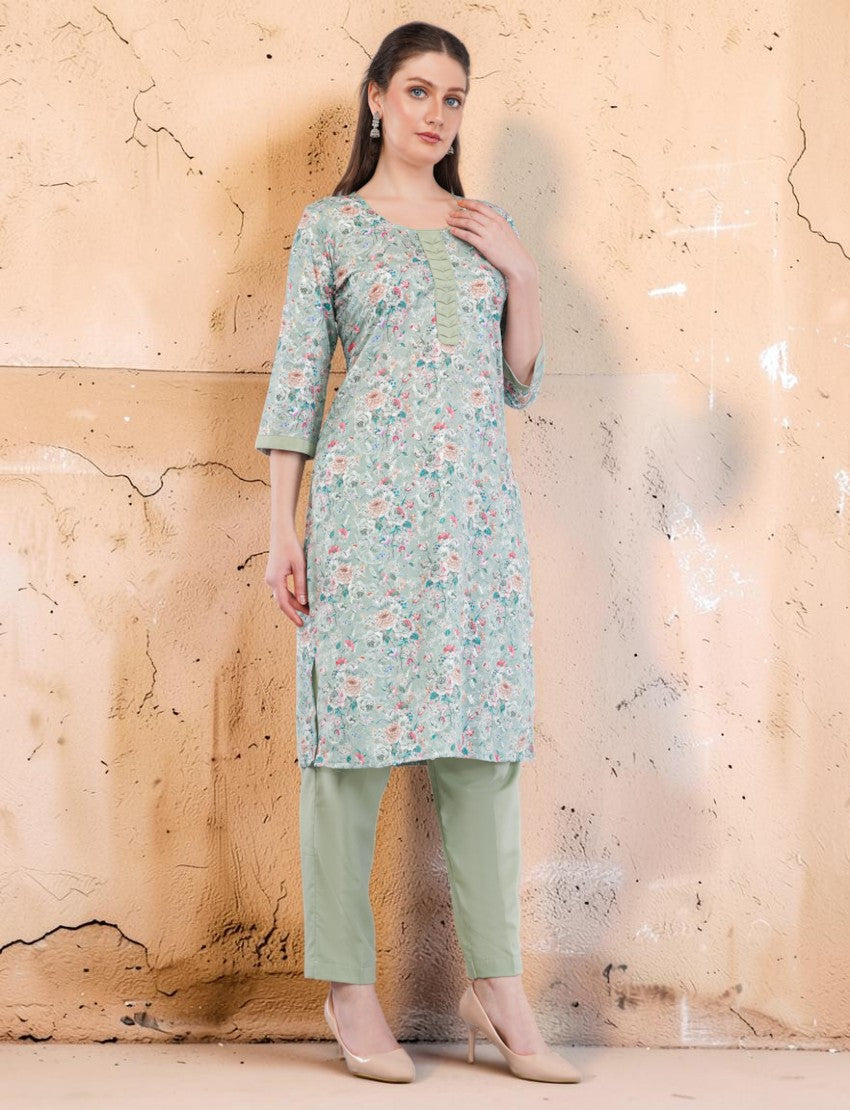 Eelika mint green cotton salwar suit set featuring a floral print kurta with embroidery, 3/4 sleeves, and trousers.