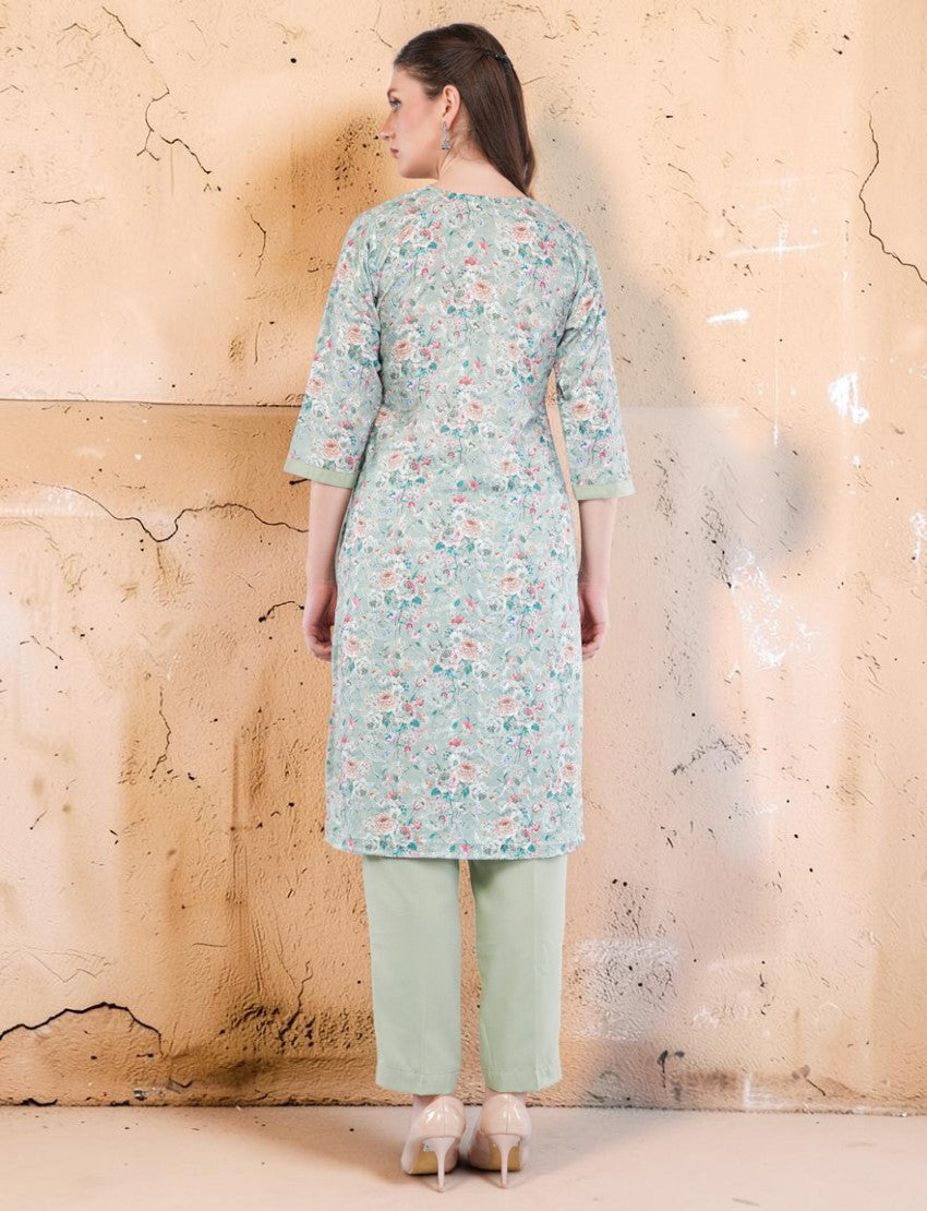 Back view of a woman wearing an Eelika mint green floral cotton salwar suit with 3/4th sleeves and matching trousers.