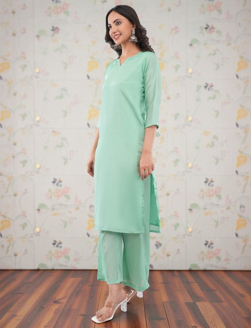 Eelika mint green silk crepe salwar suit set featuring a V-neck calf-length kurta, trousers, and matching dupatta.