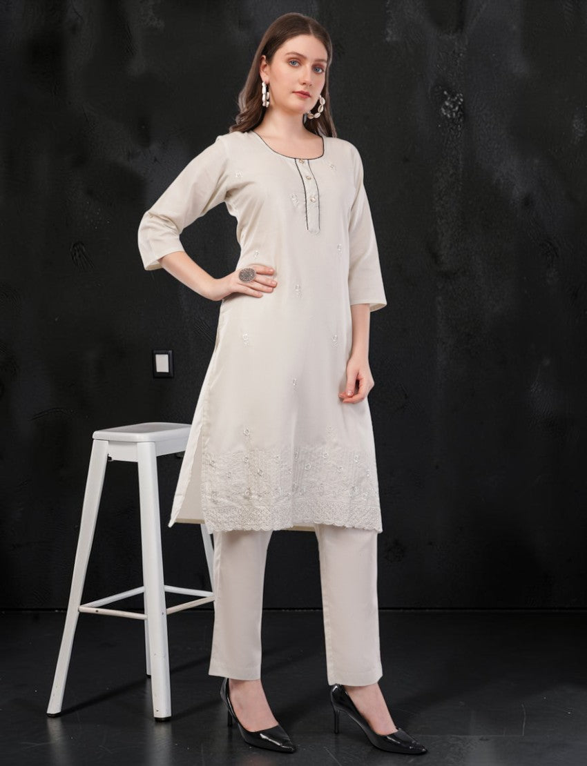 Eelika off-white cotton salwar suit set featuring knee-length embroidered kurta with 3/4 sleeves and matching trousers