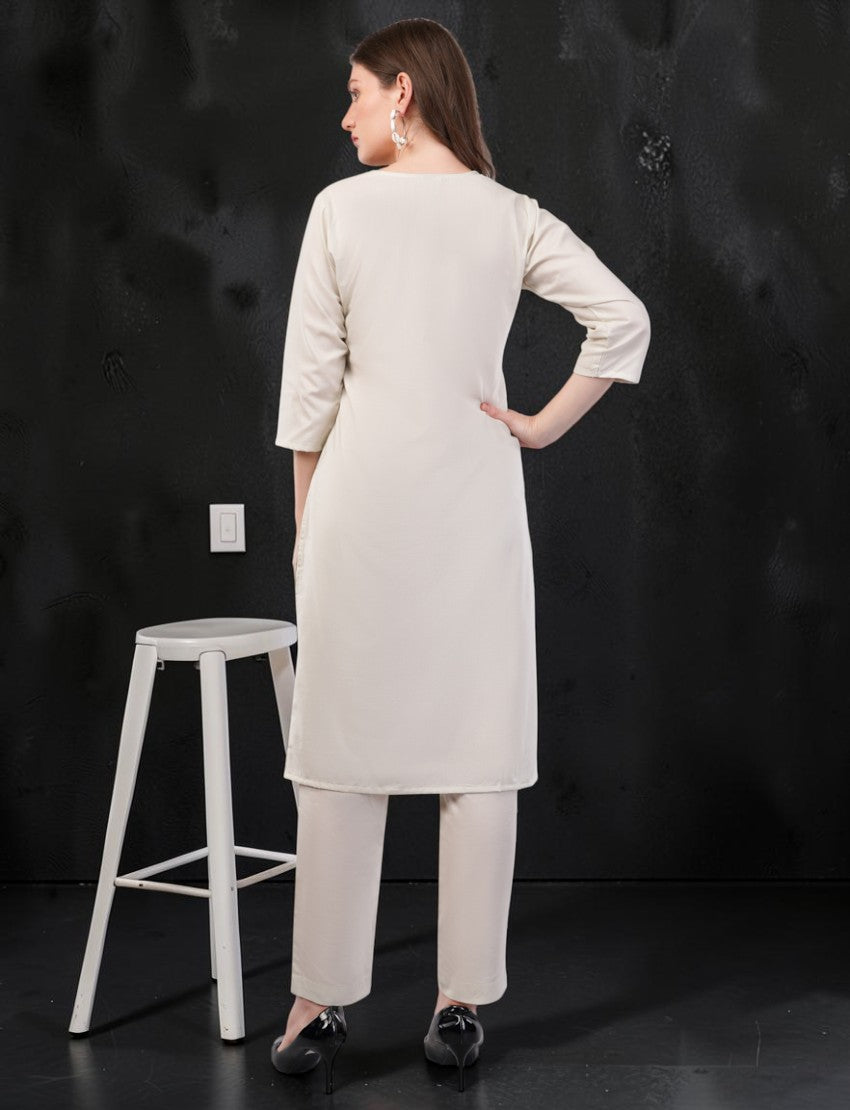 Back view of a woman wearing an off-white Eelika cotton salwar suit set with 3/4 sleeves and matching trousers.