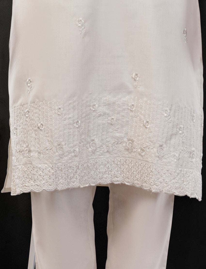 Eelika off-white cotton salwar suit featuring delicate floral embroidery and scalloped hem detail on the knee-length top