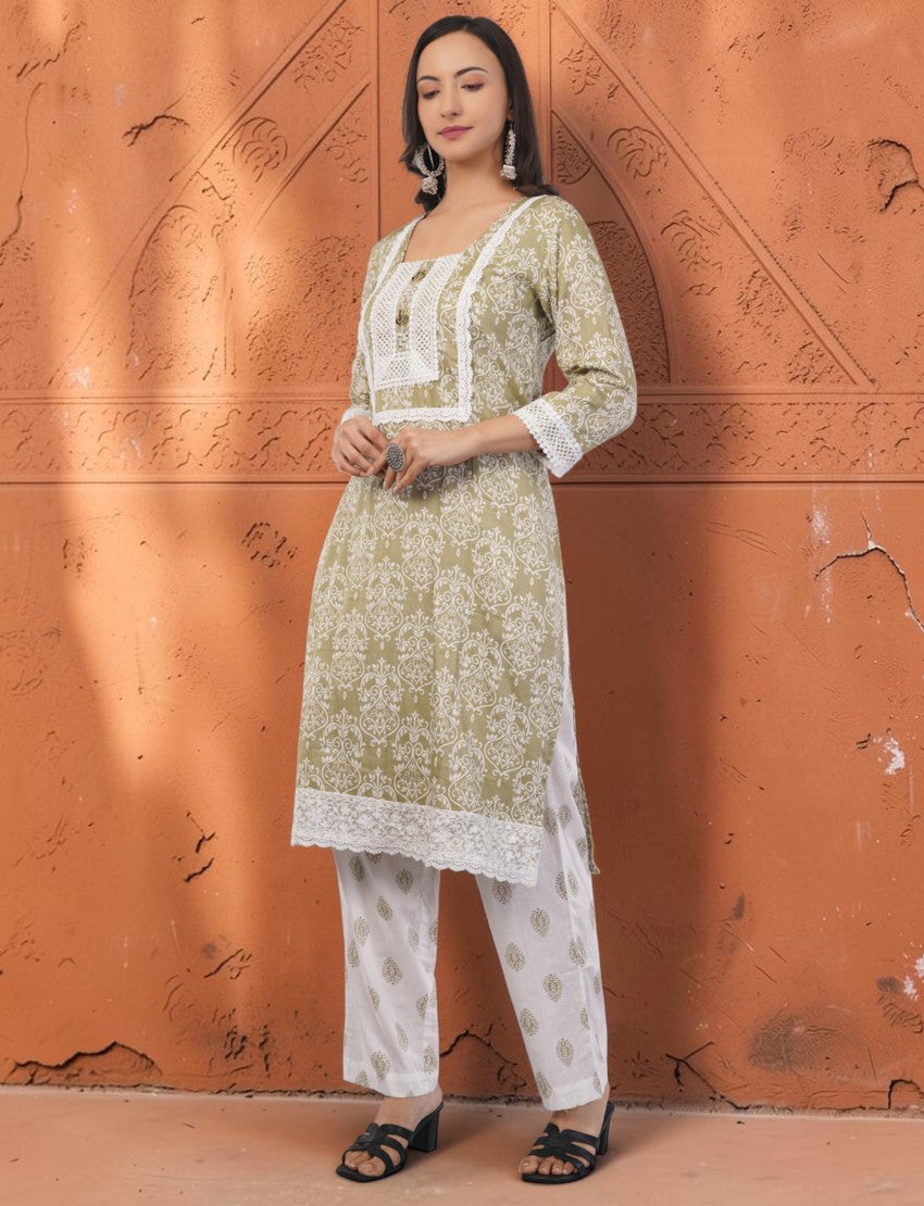Eelika olive green cotton salwar suit with white embroidery, square neck, 3/4 sleeves, and matching printed trousers.