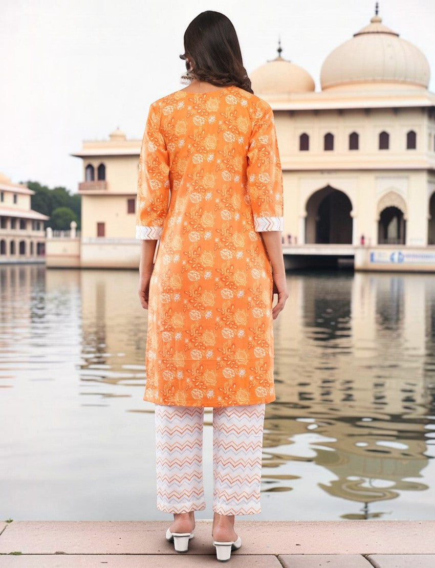 Back view of Eelika orange cotton salwar suit with floral paisley print, 3/4 sleeves, and chevron patterned trousers.