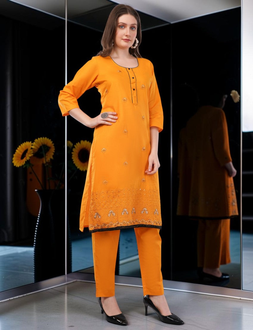 Eelika orange cotton salwar suit with knee-length embroidered kurta, 3/4 sleeves, and matching trousers