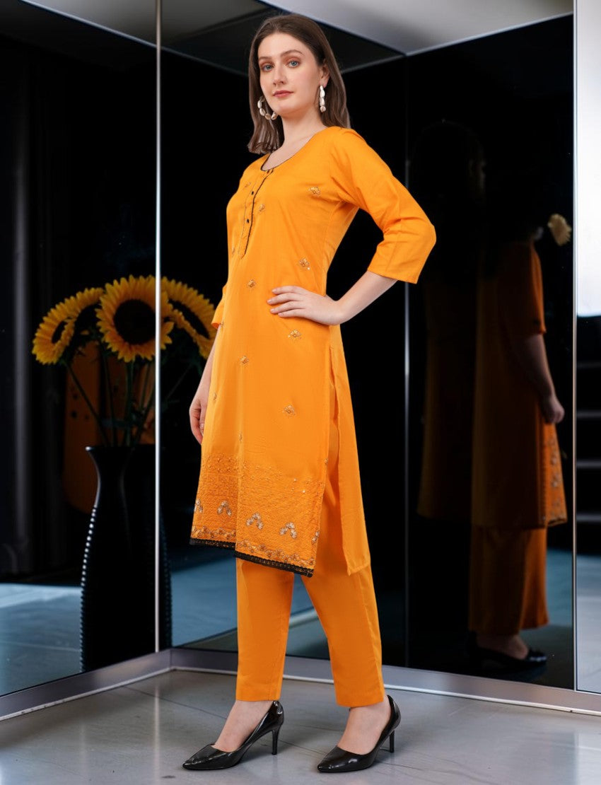 Eelika orange cotton salwar suit with knee-length embroidered kurta, 3/4 sleeves, trousers, and matching dupatta.