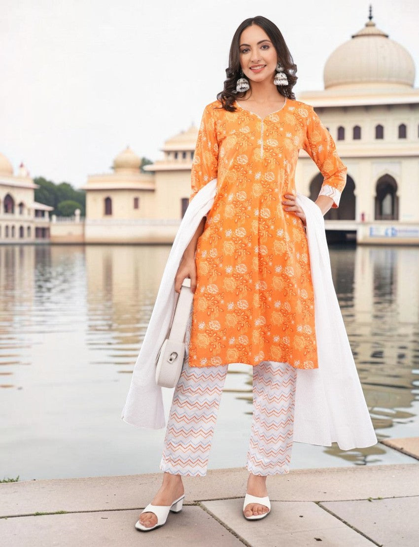 Eelika orange cotton salwar suit set with floral paisley print, V-neck, 3/4 sleeves, and patterned trousers.