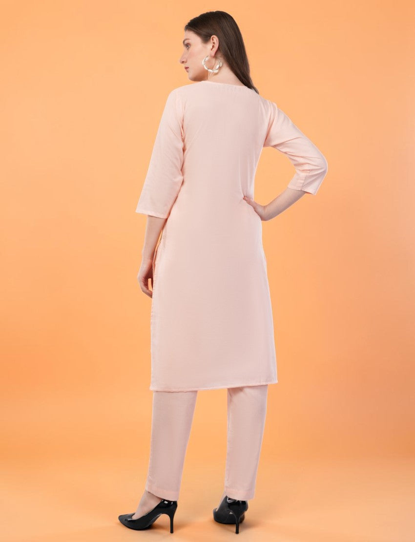 Back view of a woman wearing an Eelika peach cotton salwar suit with 3/4th sleeves and matching trousers