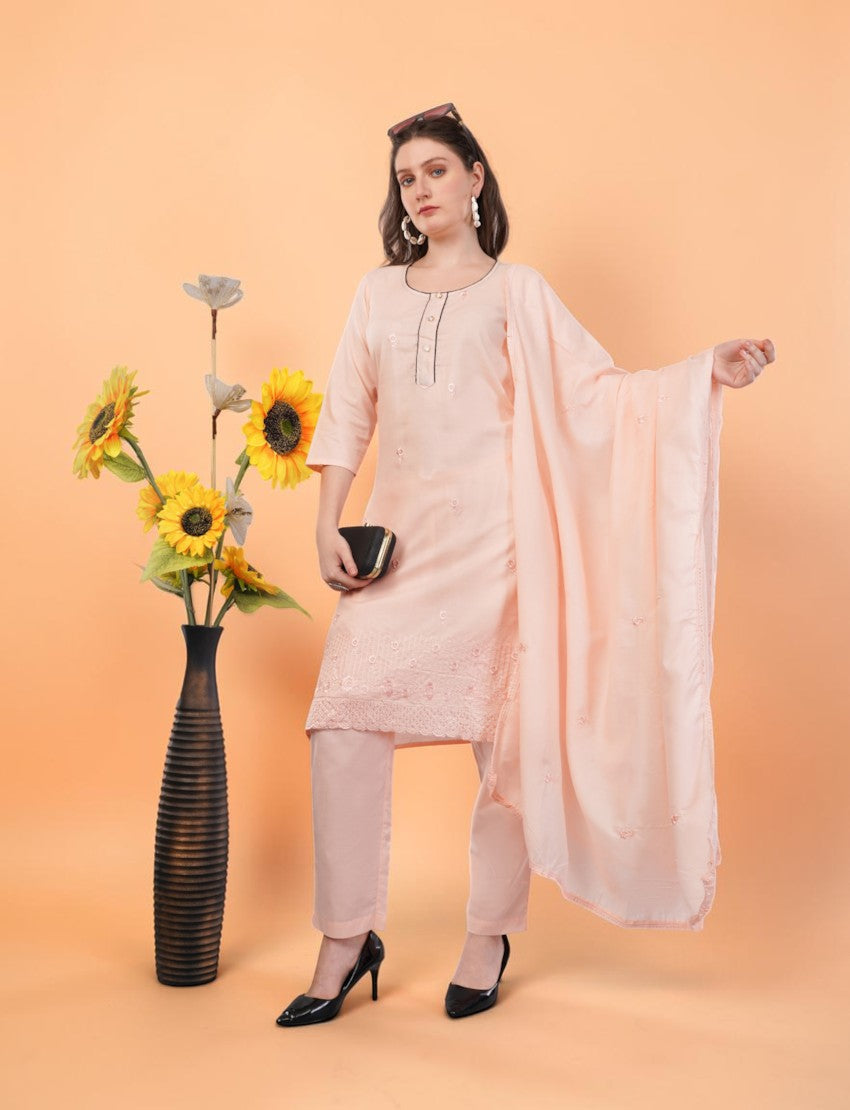 Model wearing an Eelika peach cotton salwar suit with 3/4th sleeves, embroidered details, and a matching dupatta.