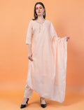 Model wearing an Eelika peach cotton salwar suit set with 3/4th sleeves, knee-length kurta, trousers, and dupatta.