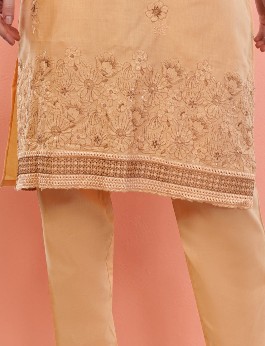Eelika peach cotton salwar suit featuring intricate floral embroidery and sequin detailing on a knee-length tunic