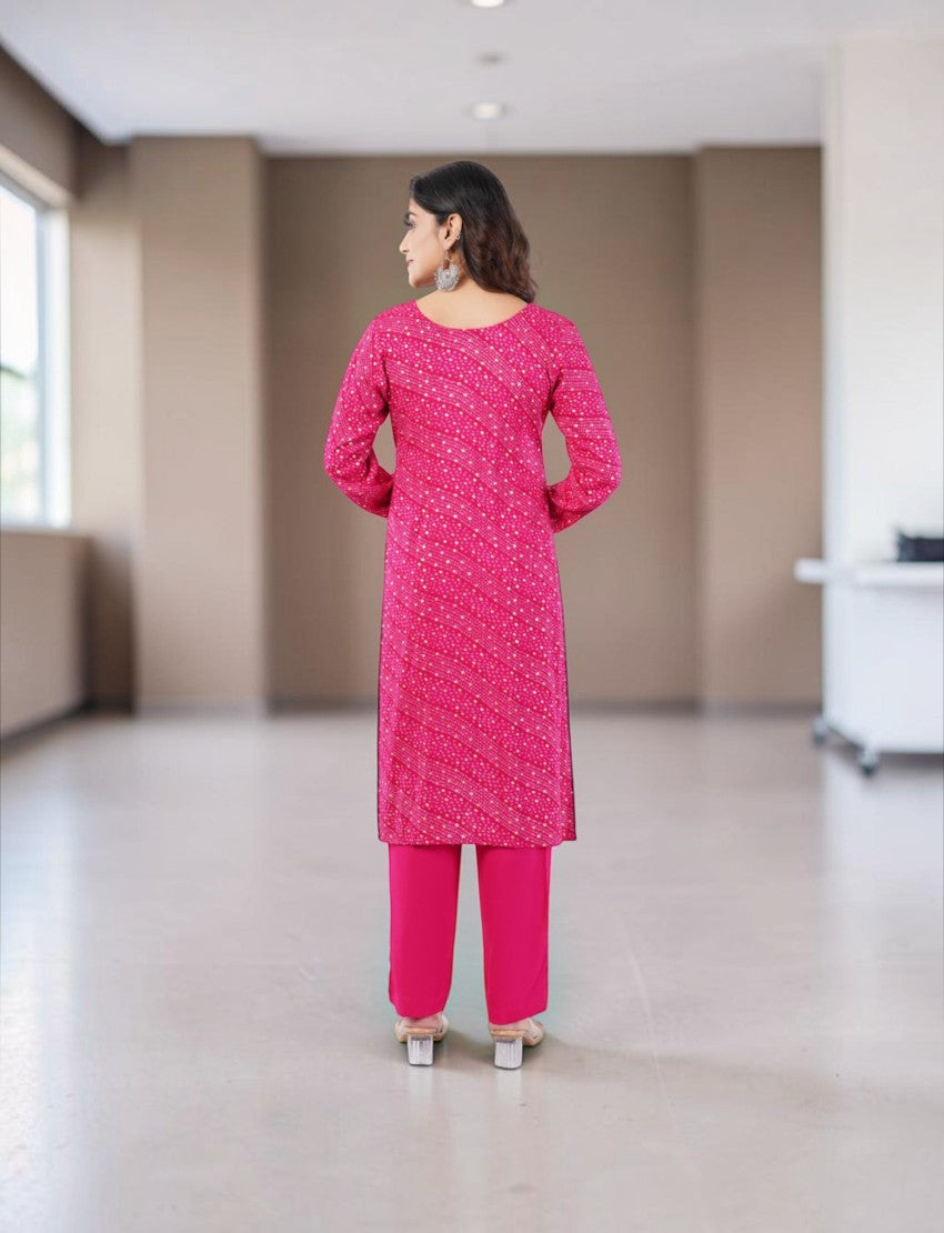Eelika pink cotton Bandhani kurta set with 3/4 sleeves and matching trousers, back view of model in indoor setting