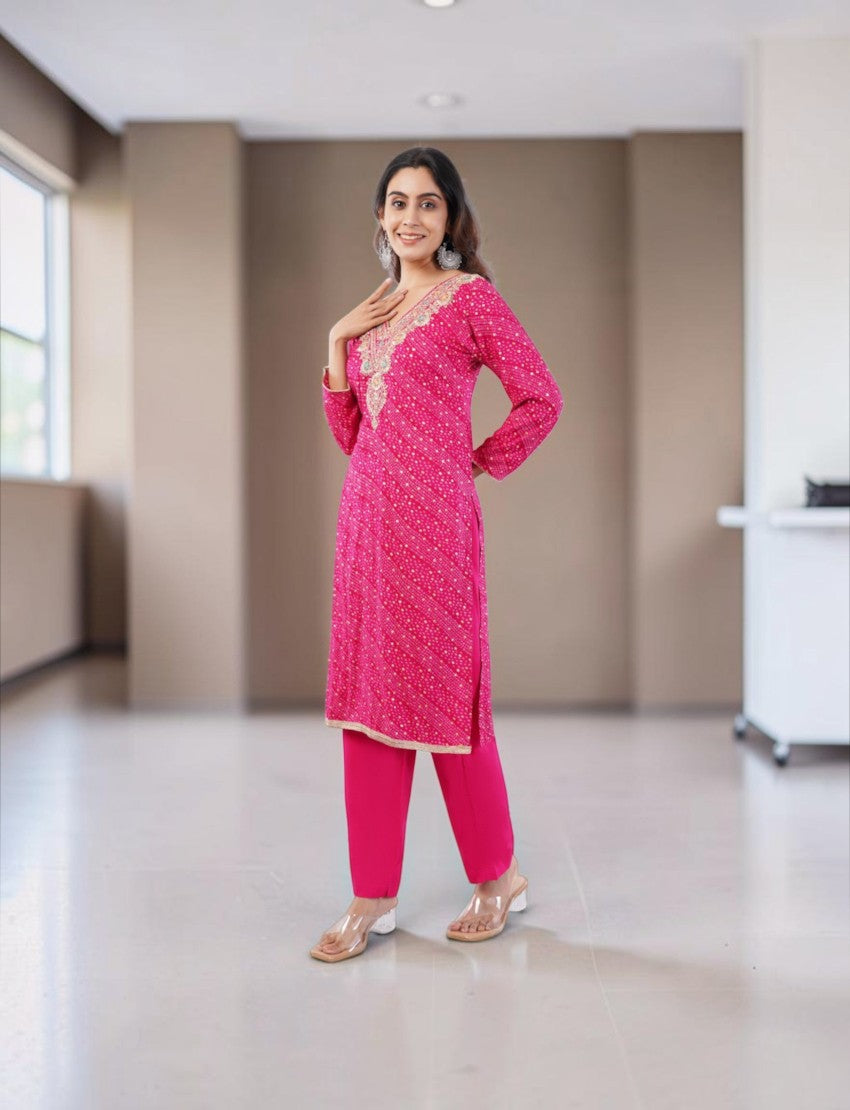 Model wearing an Eelika pink cotton Bandhani kurta set with V-neck, 3/4th sleeves, and matching dupatta