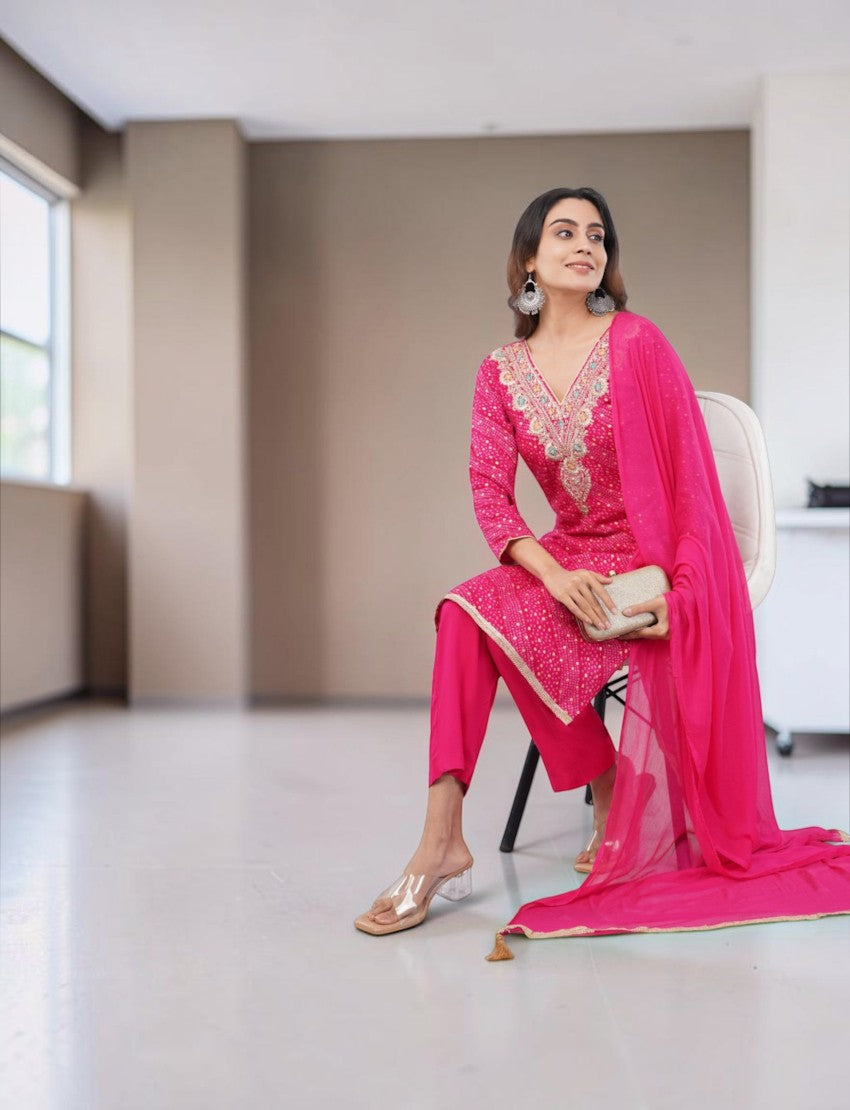 Model wearing a pink Eelika Bandhani cotton kurta set with V-neck, 3/4th sleeves, and matching dupatta