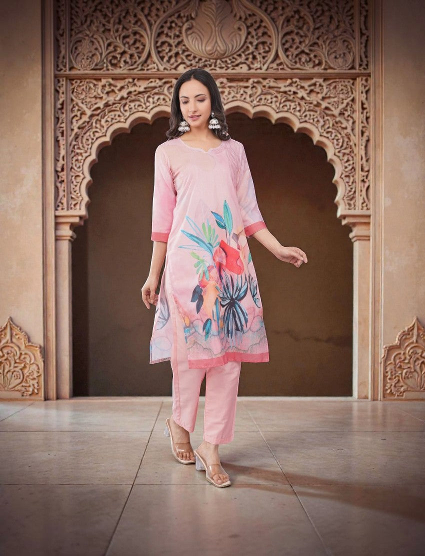 Eelika pink cotton salwar suit set with floral print, V-neck, 3/4 sleeves, and matching trousers on a model.