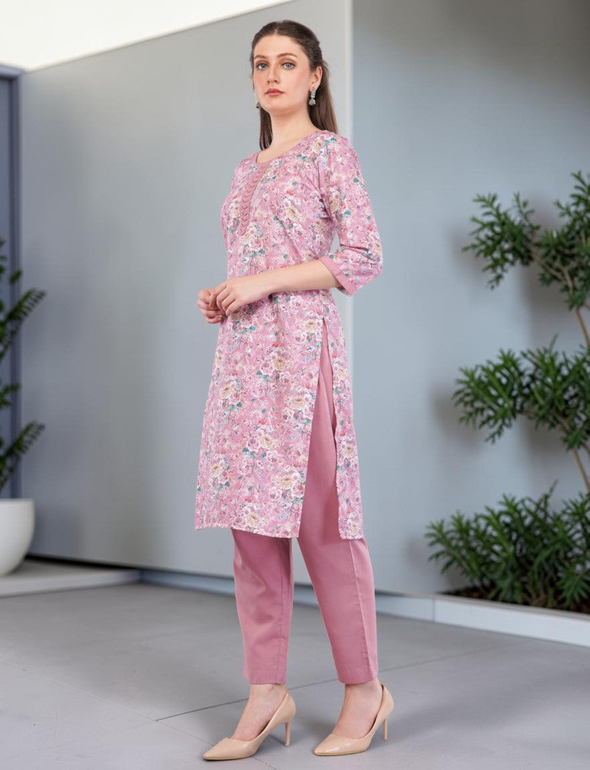 Eelika pink floral print cotton salwar suit set with 3/4th sleeves and matching trousers worn by a model