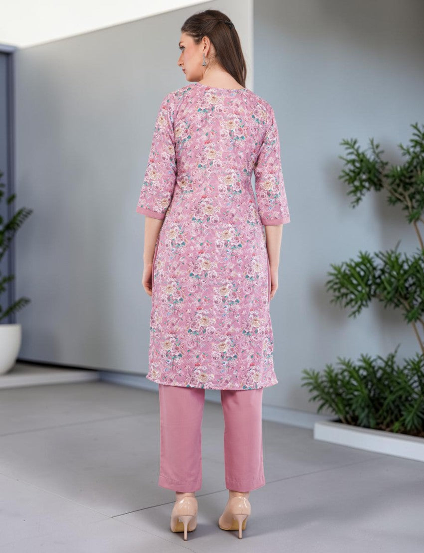 Back view of a woman wearing an Eelika pink floral print cotton salwar suit with 3/4 sleeves and matching trousers.