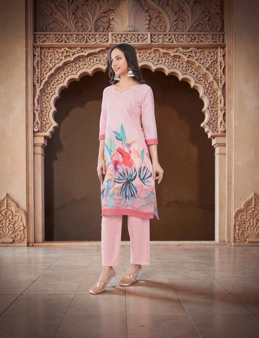 Eelika pink cotton salwar suit set with floral print, V-neck, 3/4th sleeves, and matching trousers on a model.
