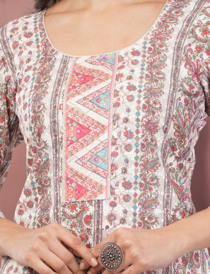 Eelika cotton salwar suit featuring a round neck, 3/4 sleeves, and intricate pink floral embroidery and print.