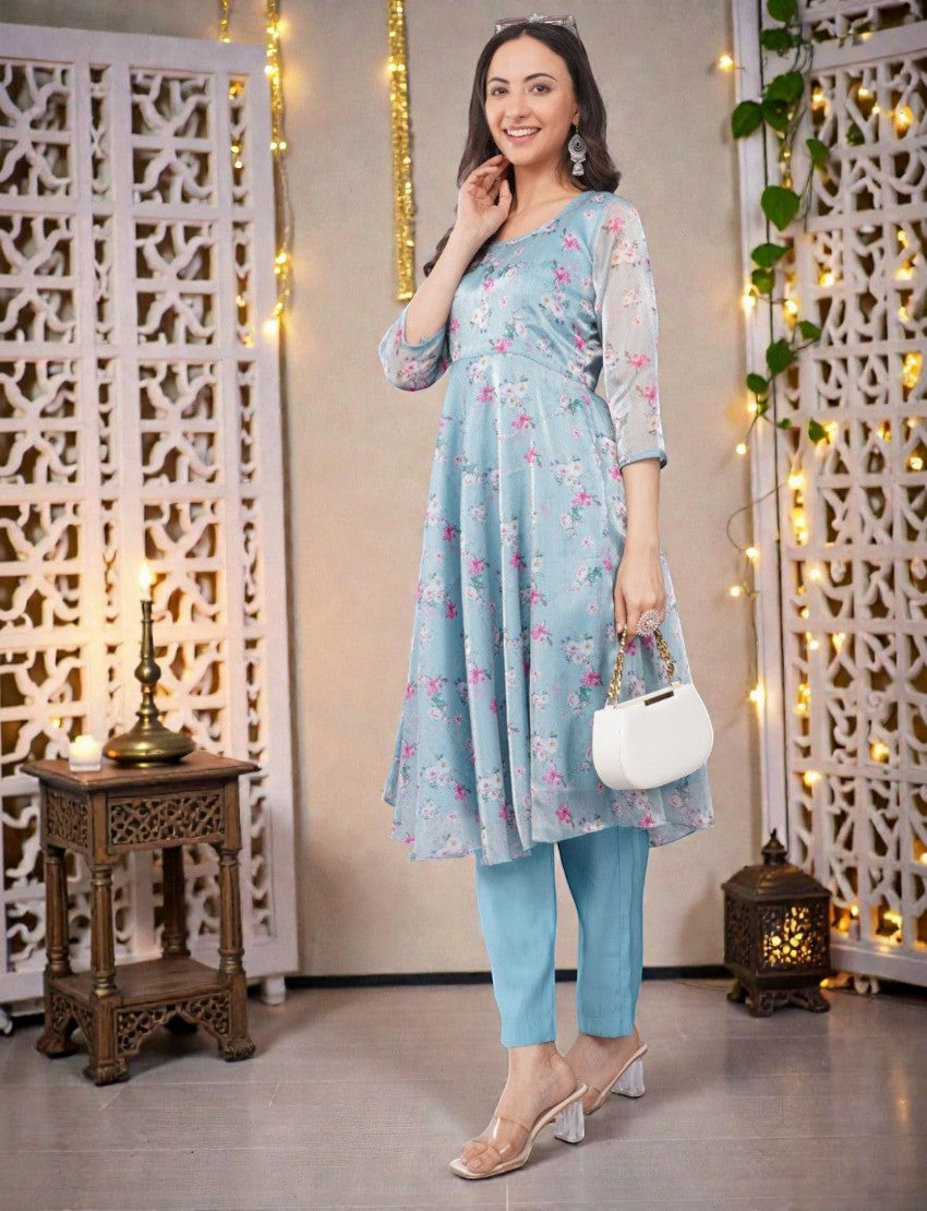 Eelika sky blue floral organza Anarkali kurta with 3/4 sleeves and cotton trousers, worn by a smiling model.