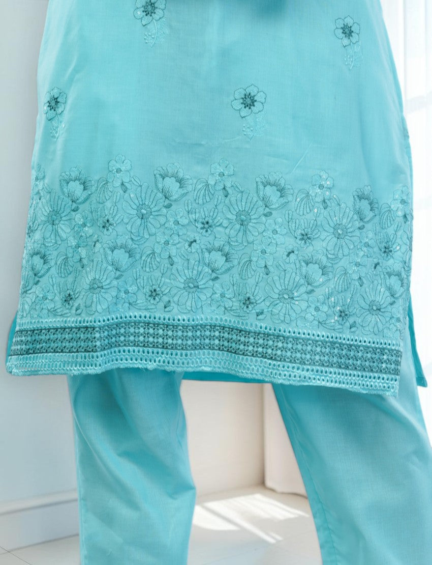 Eelika turquoise cotton salwar suit featuring intricate floral embroidery and a detailed hemline on the knee-length top