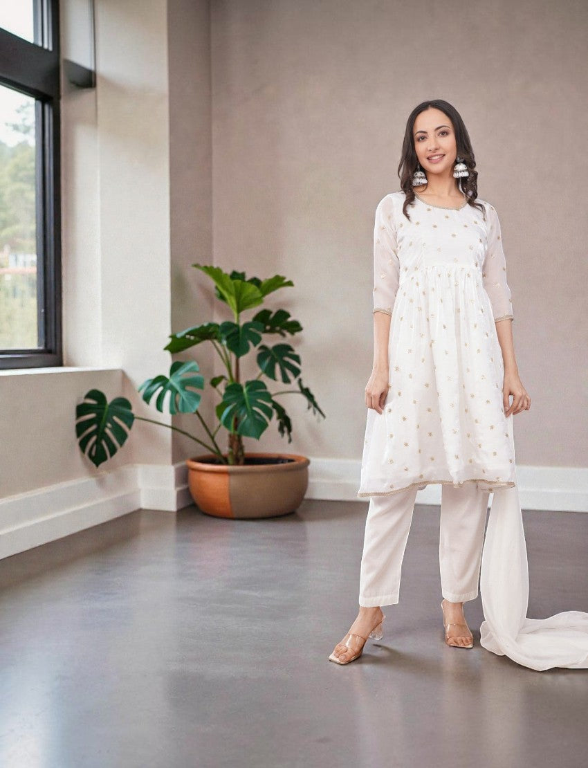 Eelika white chiffon salwar suit set with gold embroidery, 3/4th sleeves, and matching cotton trousers.