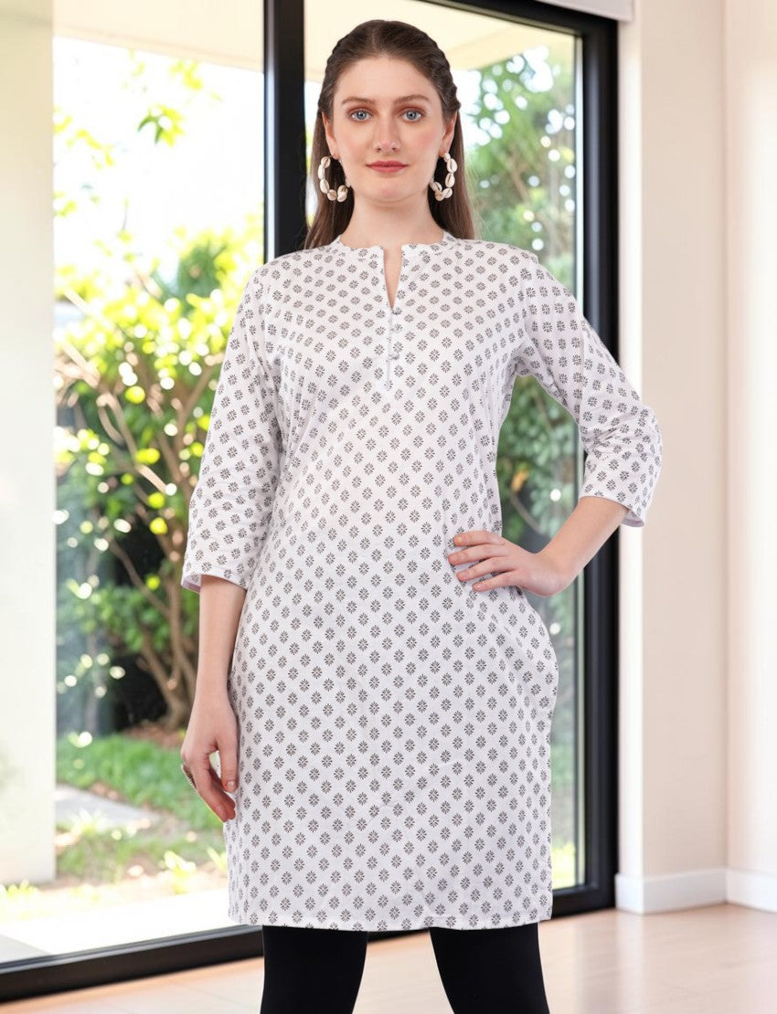 Eelika white cotton kurti featuring a geometric print, mandarin collar, and 3/4 sleeves worn by a model indoors.