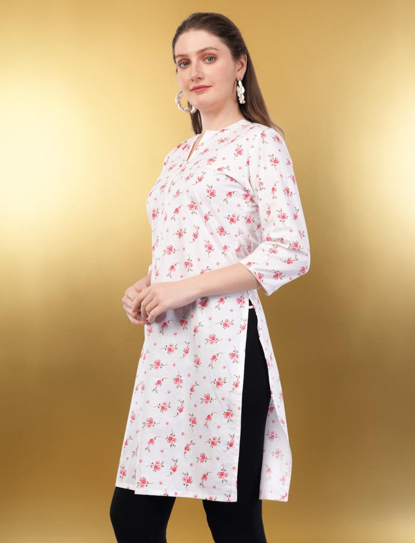 Eelika white cotton kurti with pink floral print, V-neck, and 3/4 sleeves worn by a model against a gold background