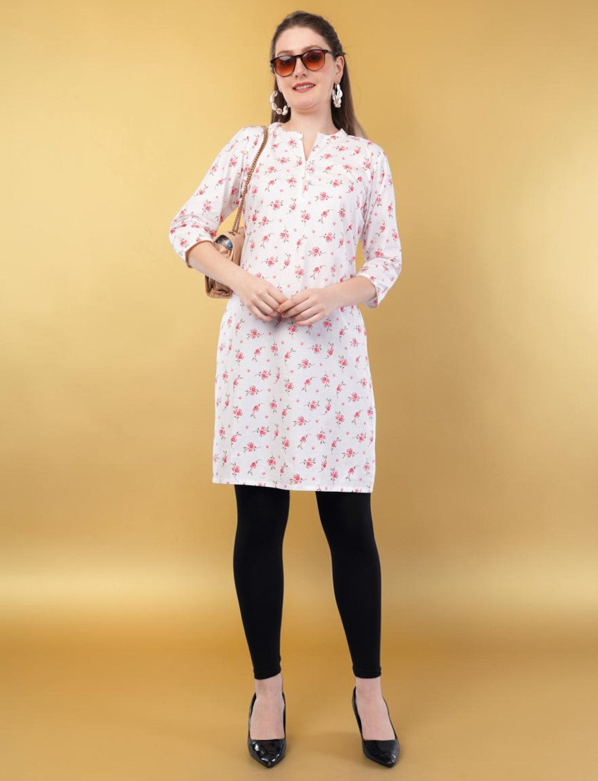 Eelika women's white cotton kurti featuring a pink floral print, V-neck, and 3/4 sleeves, worn with black leggings.
