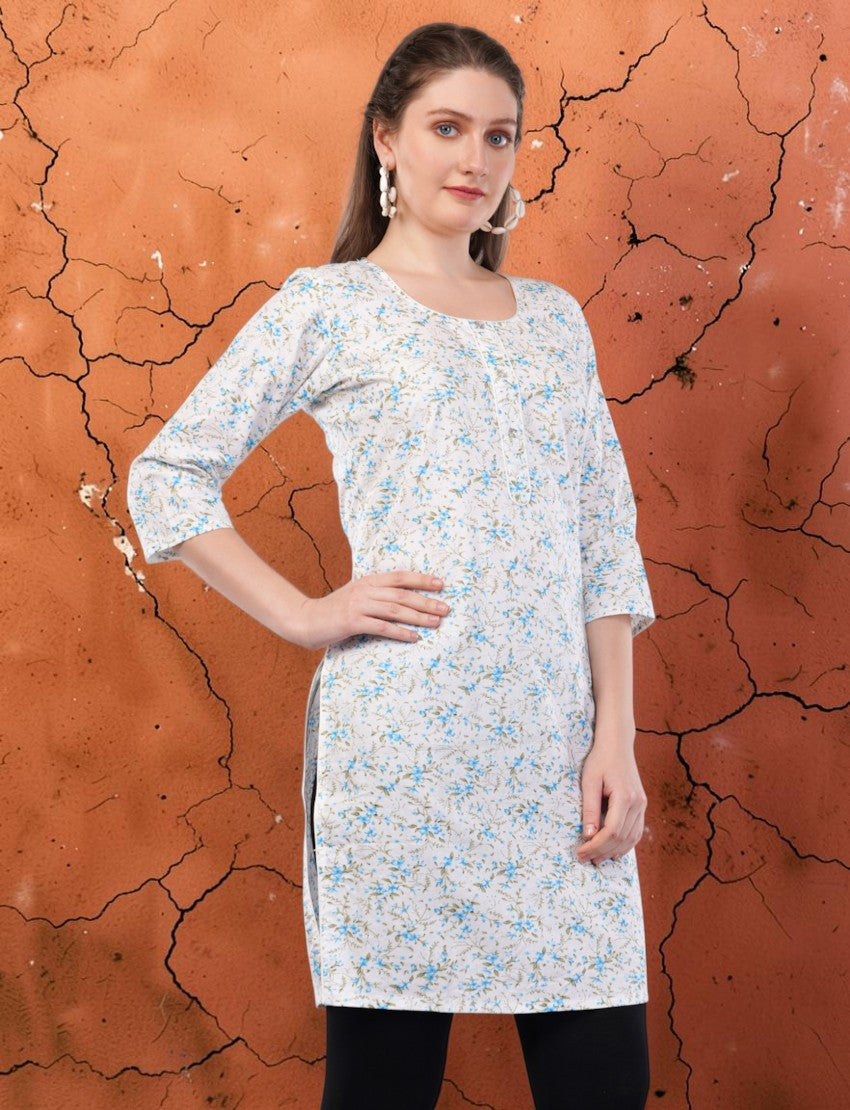 Eelika women's white cotton kurti featuring a blue floral print, round neck, and 3/4 sleeves on a model.