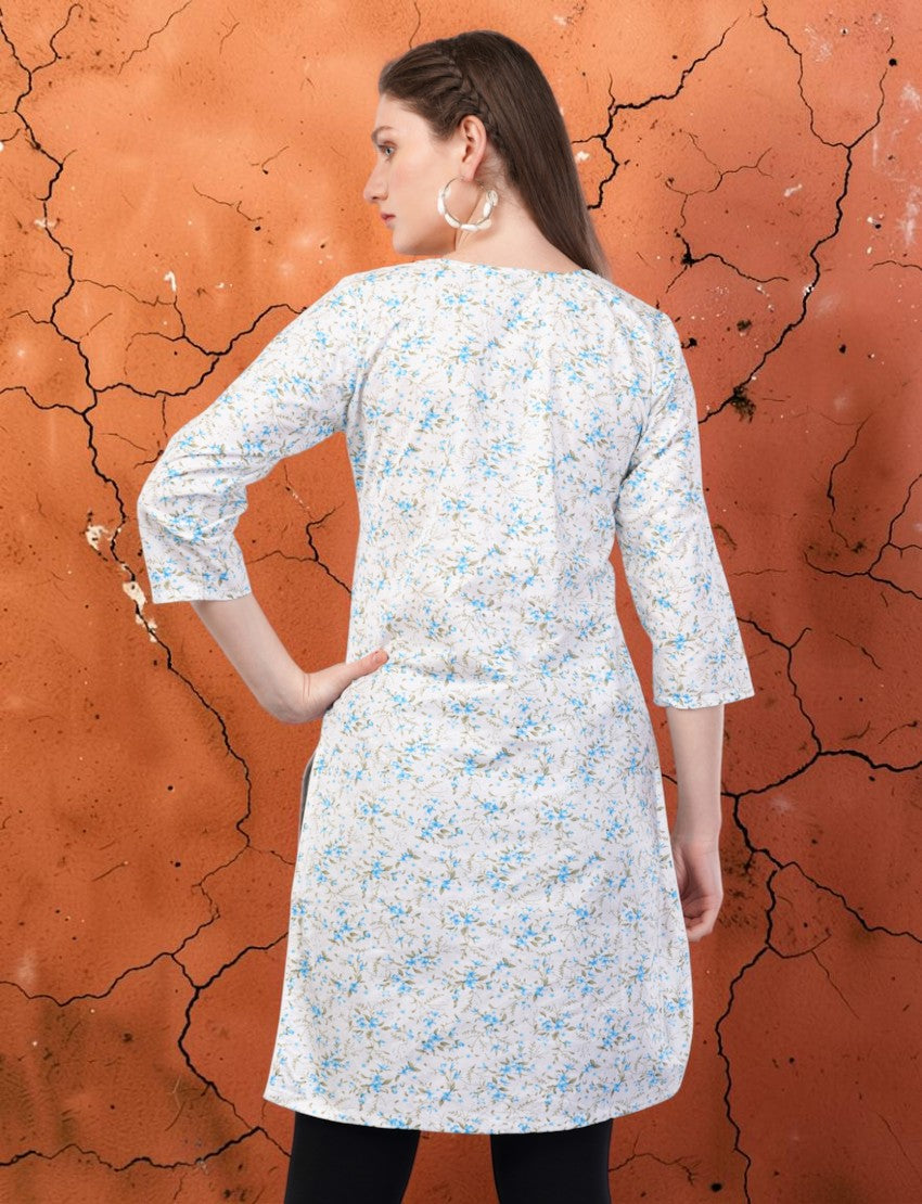 Eelika white cotton kurti with blue floral print, round neck, and 3/4 sleeves, back view on a textured background.