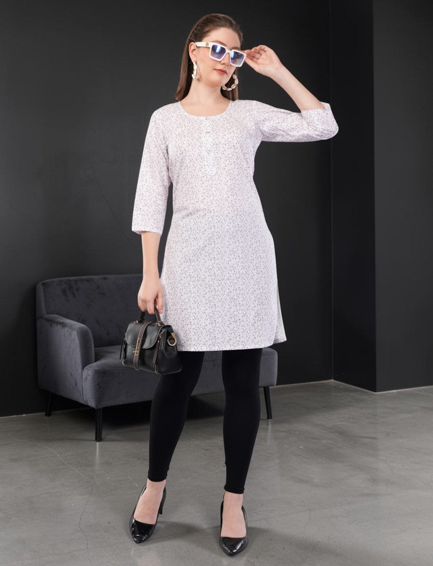 Eelika women's white cotton kurti with purple floral print, round neck, and 3/4 sleeves worn with black leggings